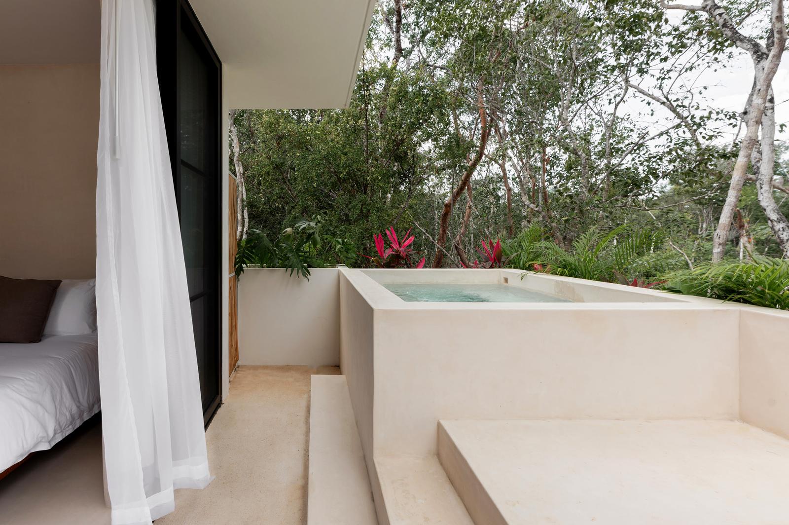 Bedroom opening onto its private plunge pool