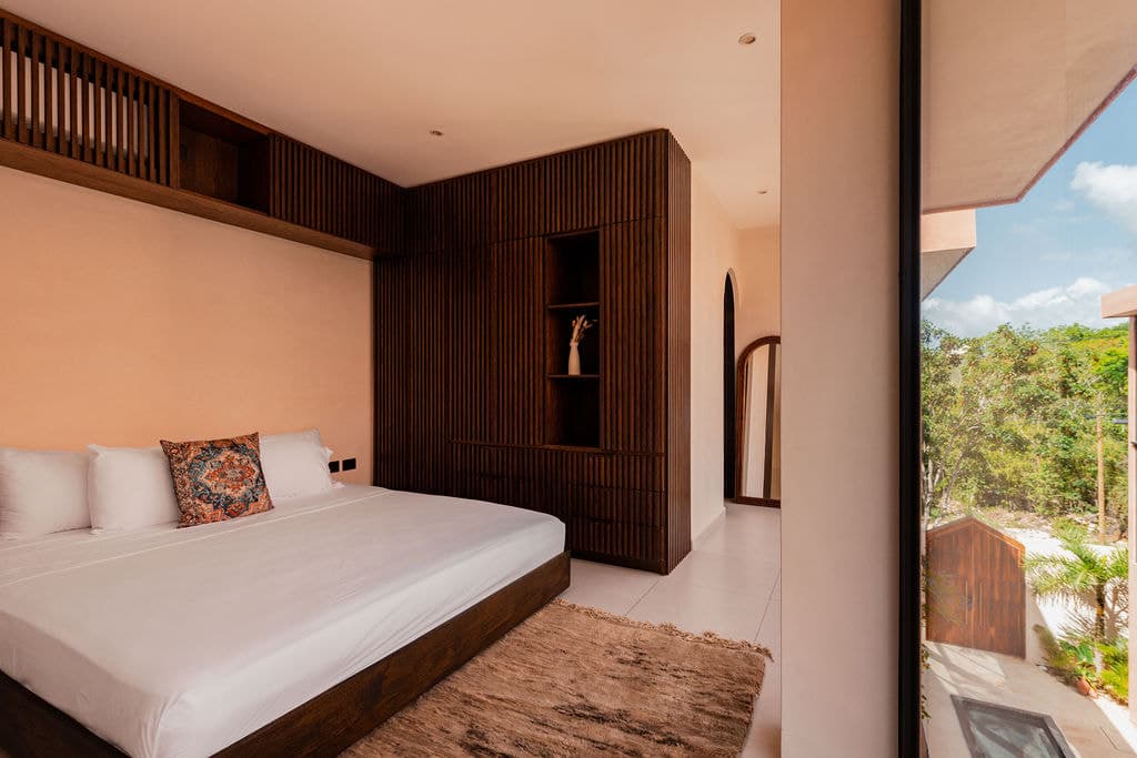 Bedroom with carved headboard niche and lanterns