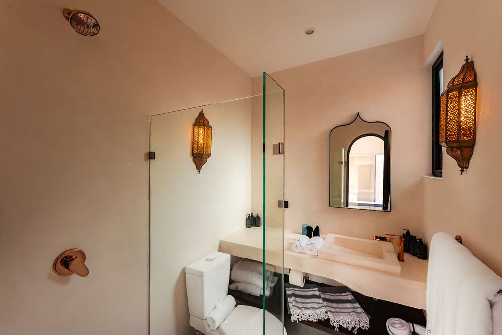 Washroom with arched mirror and window