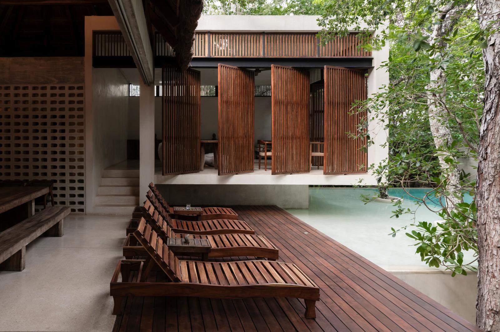Sun loungers on the timber deck beside the pool