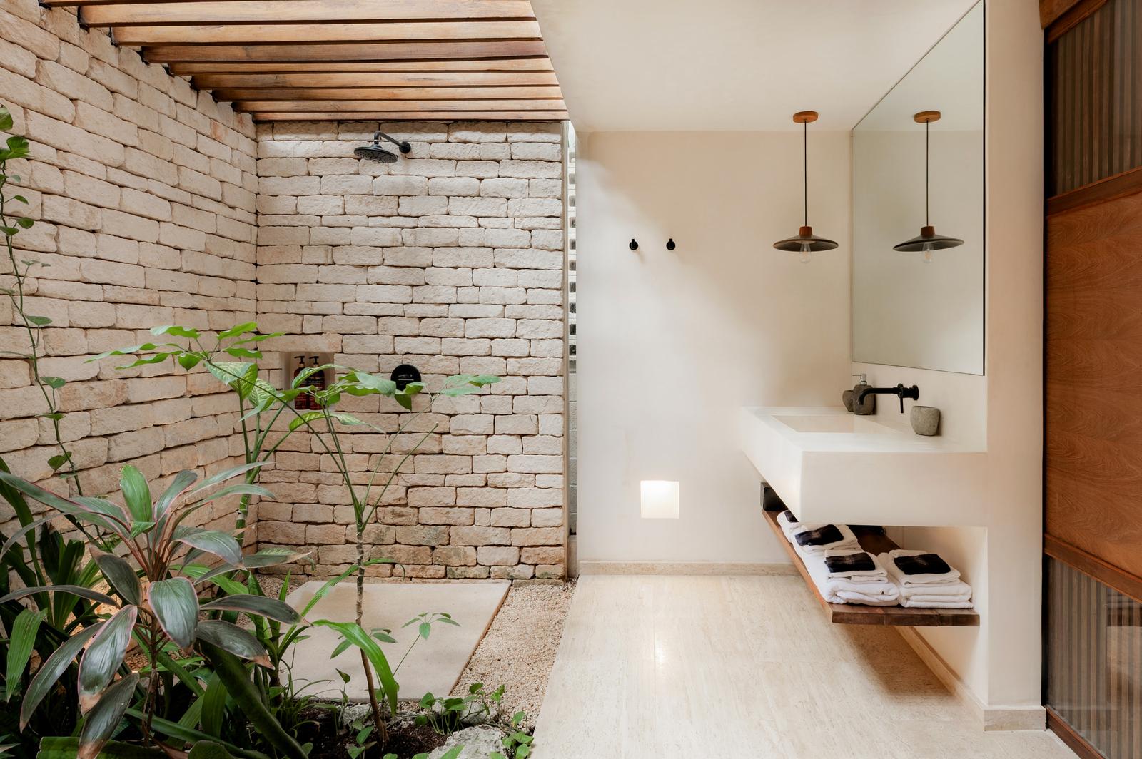 Open-air shower and basins among planting