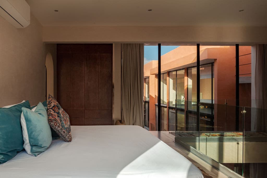 Penthouse bedroom with a glass floor panel to the level below