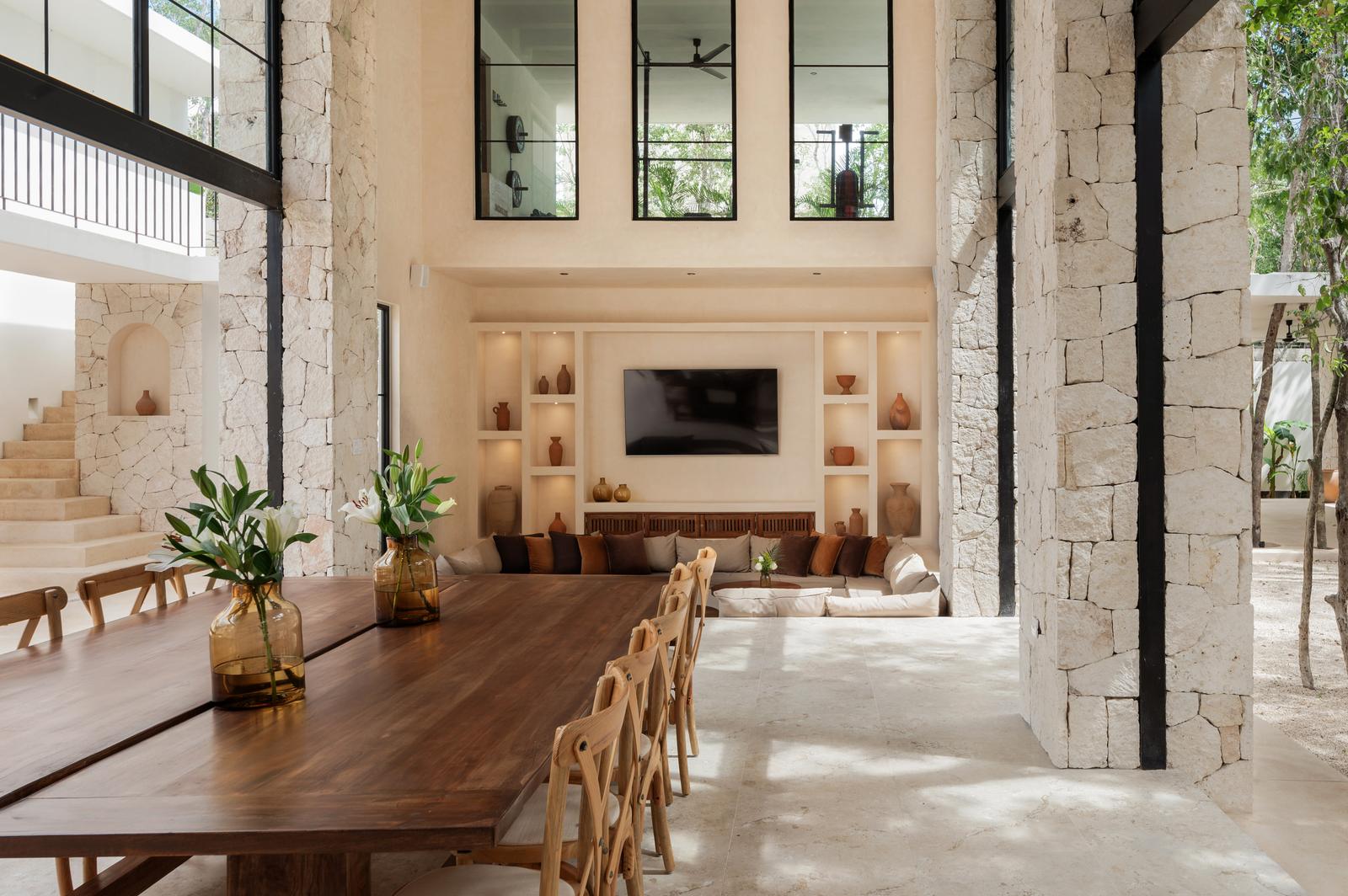 Dining table set against the media wall