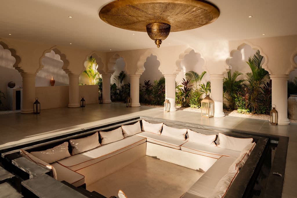 Sunken lounge with low seating beside the water