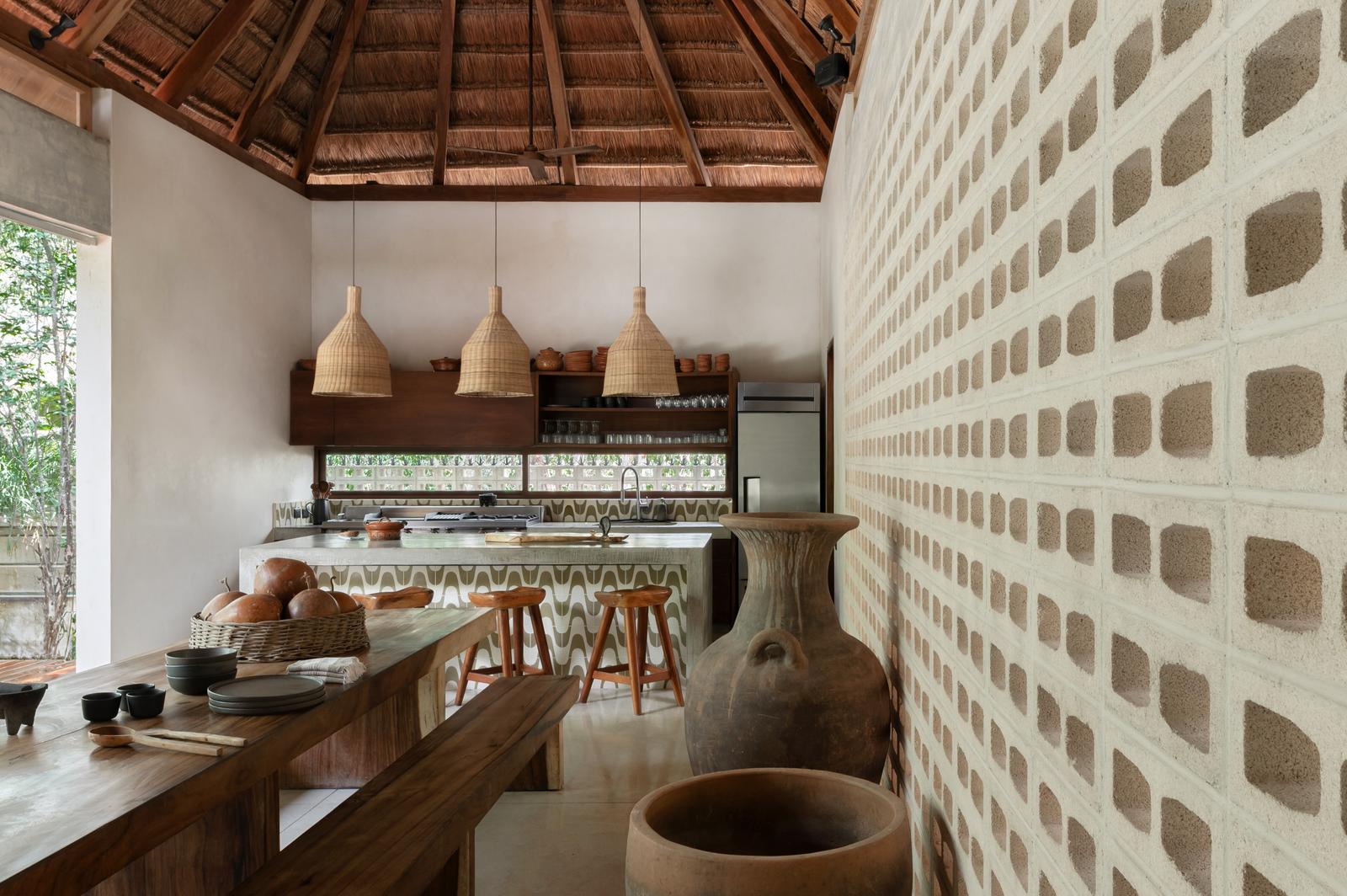 Kitchen bar with woven pendant lights and a breeze-block wall