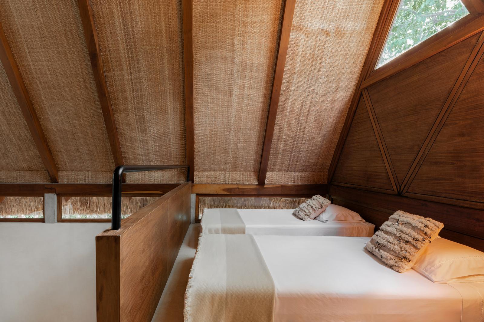 Twin beds in the loft of a lodge
