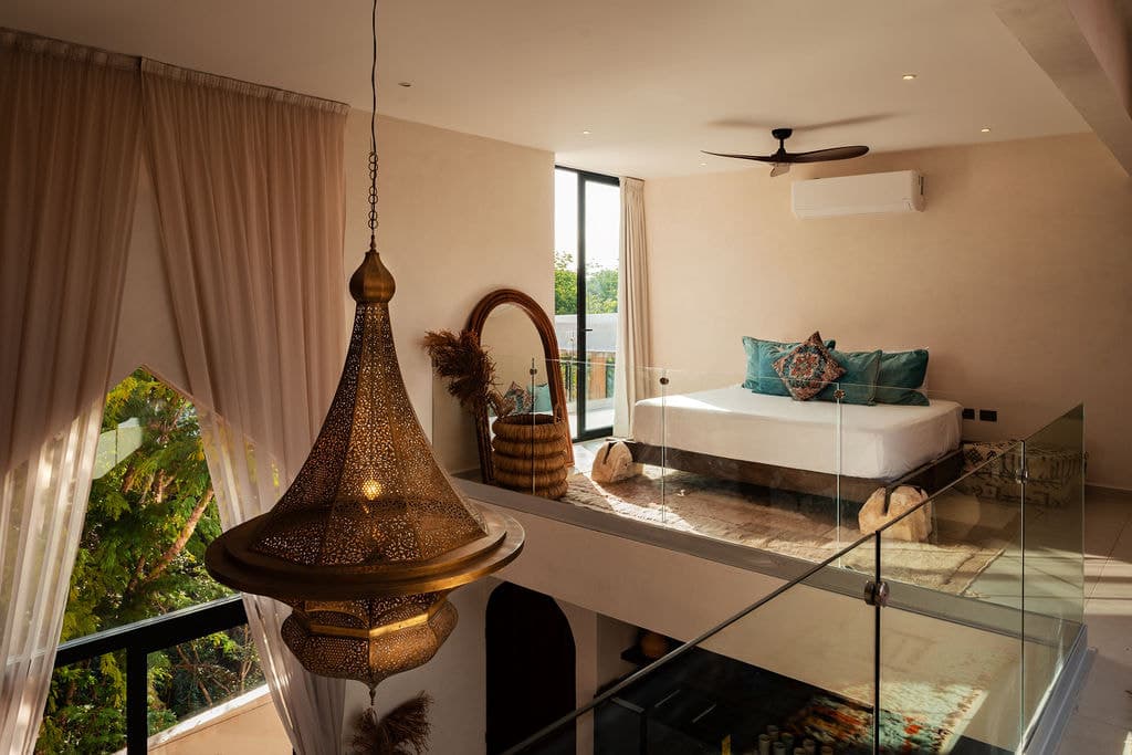 Upper penthouse level with brass pendant and bathtub