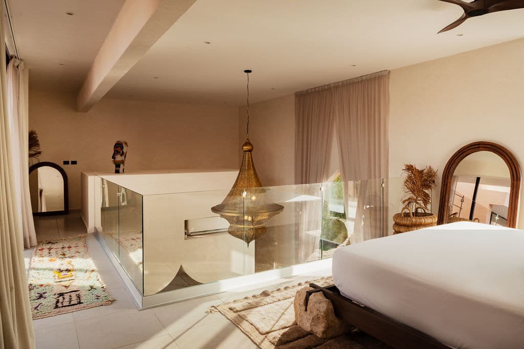 Bedroom with a bathtub set beside the bed