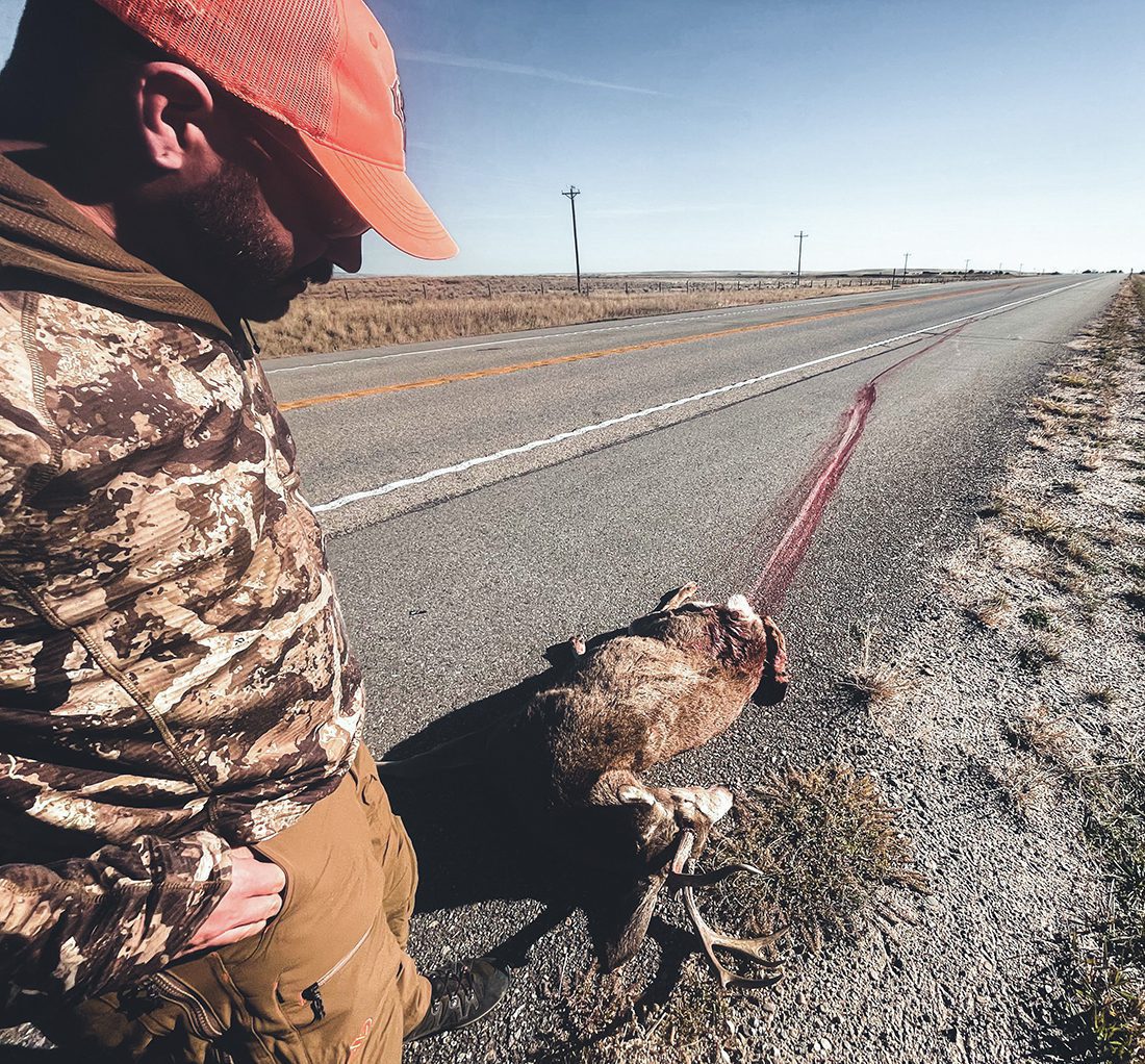 Hunter Matt Standing Over Roadkill Buck Near Casper