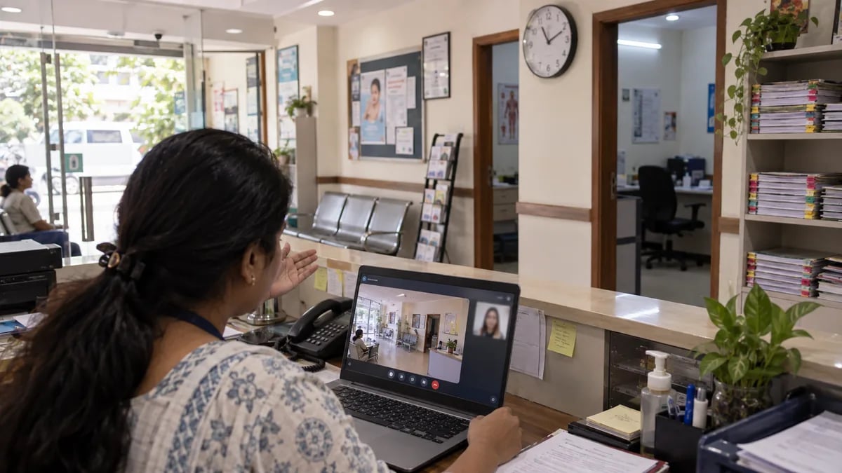 A clinic receptionist on a video call, panning the camera across reception to verify the business location