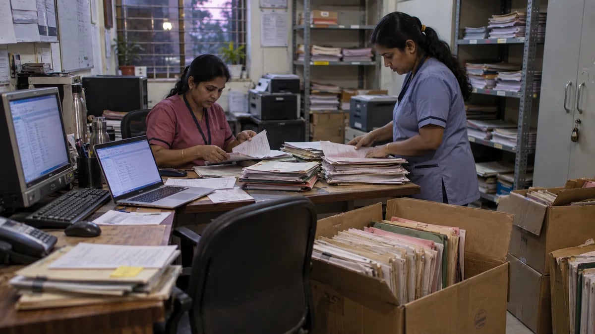 Clinic staff moving patient records from an old system and paper files during a software switch