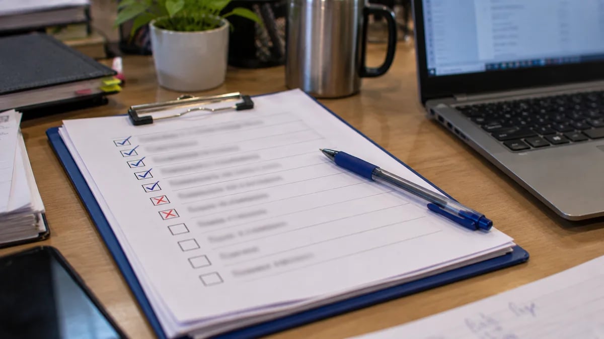 A printed buyer's checklist being ticked off during a live product demo