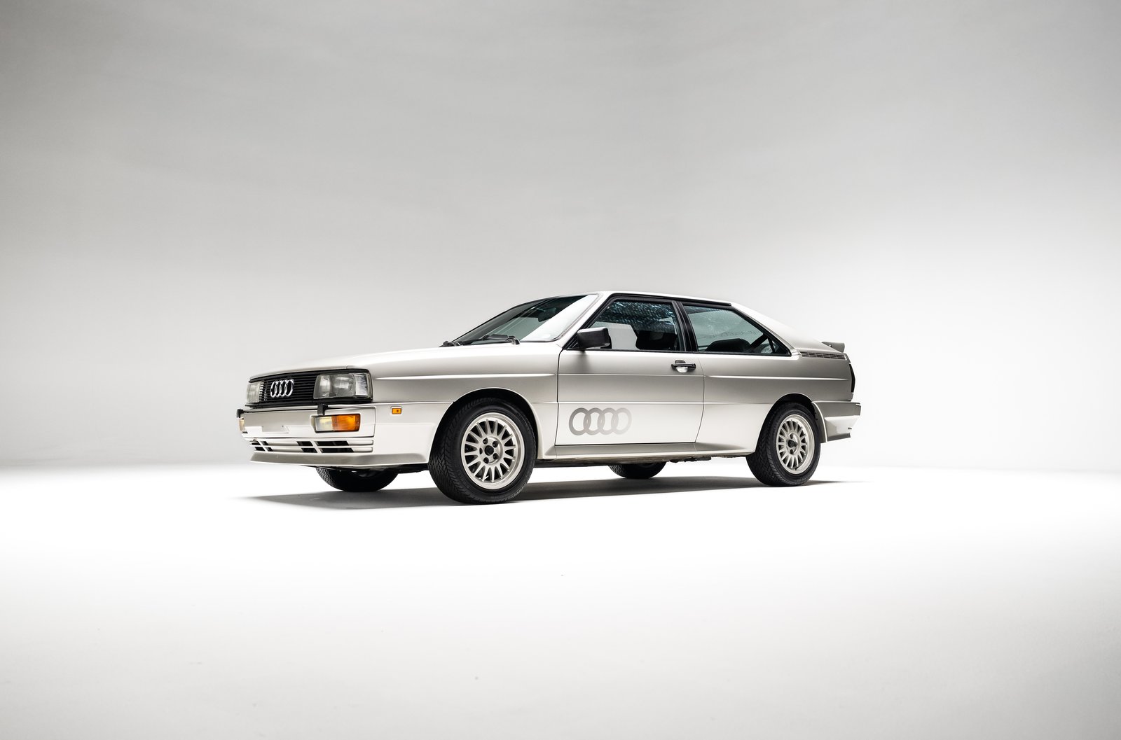 1986 Audi WR Ur-Quattro in Zermatt Silver shown at a front three-quarter angle in studio.