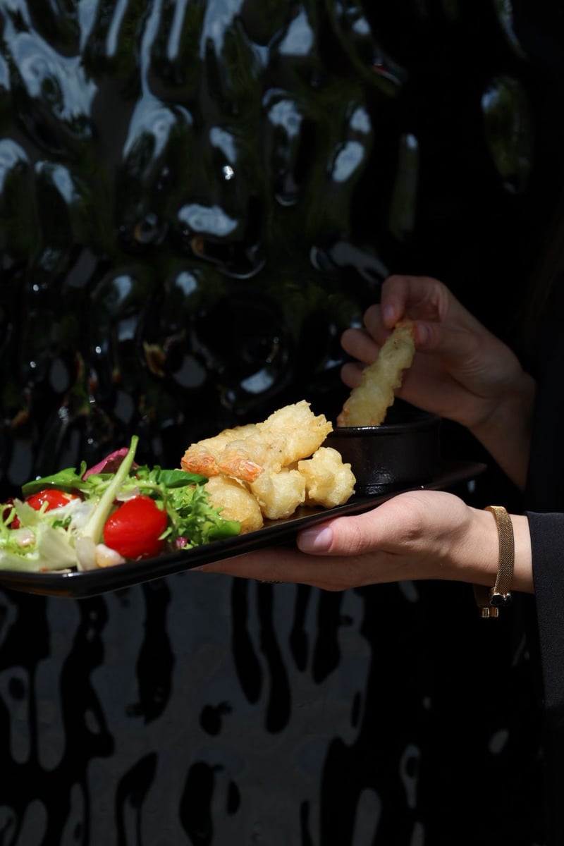 Krewetki w tempurze 6 sztuk z dipem i mixem sałat podane na talerzu, chrupiąca przystawka w restauracji, danie seafood gourmet