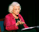 Sandra Day O'Connor gestures while speaking as she sits in a chair.