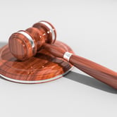 A gavel sits on a pedestal