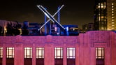 Workers install lighting on an "X" sign atop the company's headquarters in San Francisco.