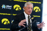 Kirk Ferentz gestures with both hands while speaking at Iowa's media day.