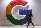 A woman walks past the logo for Google at the China International Import Expo.