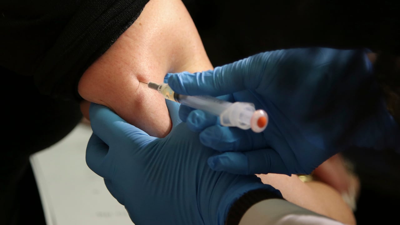 A vaccine against measles, mumps and rubella is administered to a woman.