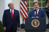 Mike Lindell speaks as Donald Trump listens during a press conference in the White House's Rose Garden.