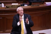 Jim Justice applauds while standing in the House chambers at the West Virginia State Capitol Building.