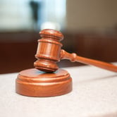 A gavel sits on its block.