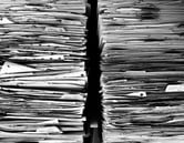 Two stacks of documents pile high
