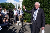 Bernie Sanders waves after he finishes speaking to reporters.