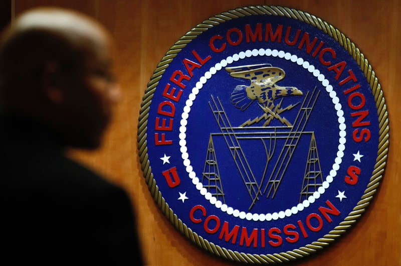The Federal Communications Commission seal on a wall.