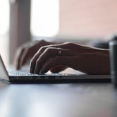 Man typing on a laptop