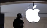 An Apple store employee wearing a face shield.