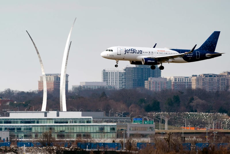 A JetBlue plane lands at Reagan Washington National Airport in Arlington, Va.