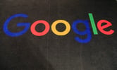The Google logo is displayed on a carpet in an entrance hall.