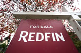 A Redfin "for sale" sign stands in front of a house in Seattle.