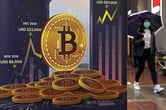 An advertisement for Bitcoin is displayed on a street in Hong Kong.