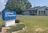 A blue Planned Parenthood sign sits outside of a clinic