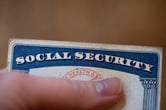 A person holds a Social Security card.