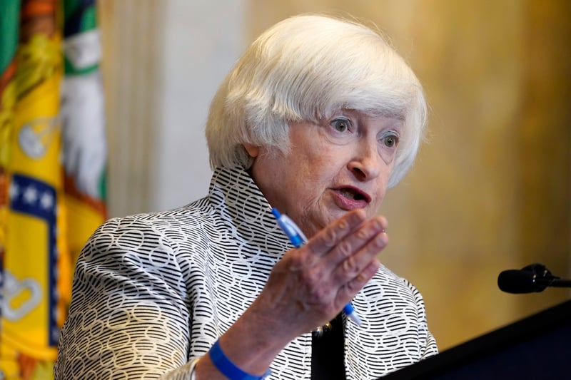 Janet Yellen gestures while speaking during a news conference.