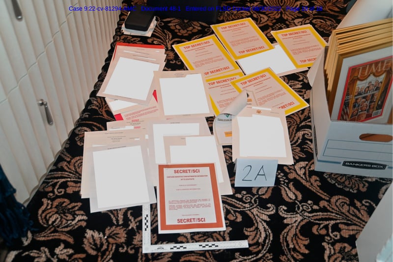 Piles of classified documents are laid out on the carpet.