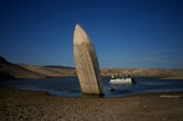 A formerly sunken boat sits upright in Lake Mead.