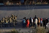 U.S. military members stop migrants from crossing into El Paso, Texas.