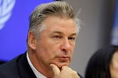 Alec Baldwin rests his chin on his hand at a news conference at United Nations headquarters.