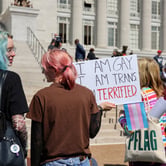 Protesters hold signs in support of transgender care for minors at the Missouri State Capitol on March 29, 2023. (Credit: Be Lovely Photography.)