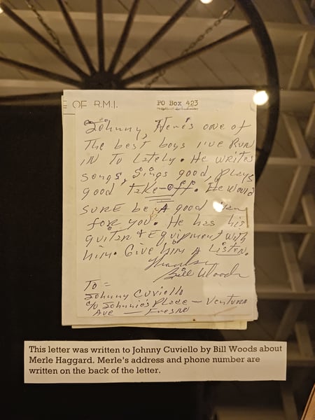 A letter written to Johnny Cuviello by Bill Woods about Merle Haggard, who's name and address are on the back.