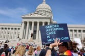 Protesters hold signs in support of transgender care for minors at the Missouri State Capitol on March 29, 2023. (Credit: Be Lovely Photography.)