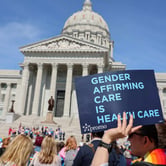 Protesters hold signs in support of transgender care for minors at the Missouri State Capitol on March 29, 2023. (Credit: Be Lovely Photography.)
