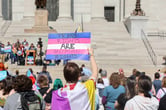 Protesters hold signs in support of transgender care for minors at the Missouri State Capitol on March 29, 2023. (Credit: Be Lovely Photography.)