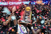 Confetti falls as players on LSU's women's basketball team celebrate after winning the national title.