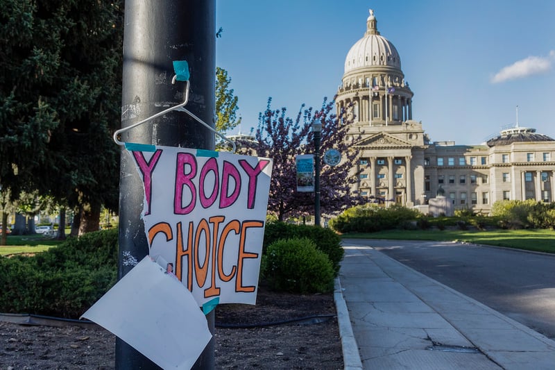 A torn sign reading "my body, my choice" is taped to a streetlight near the Idaho state Capitol.